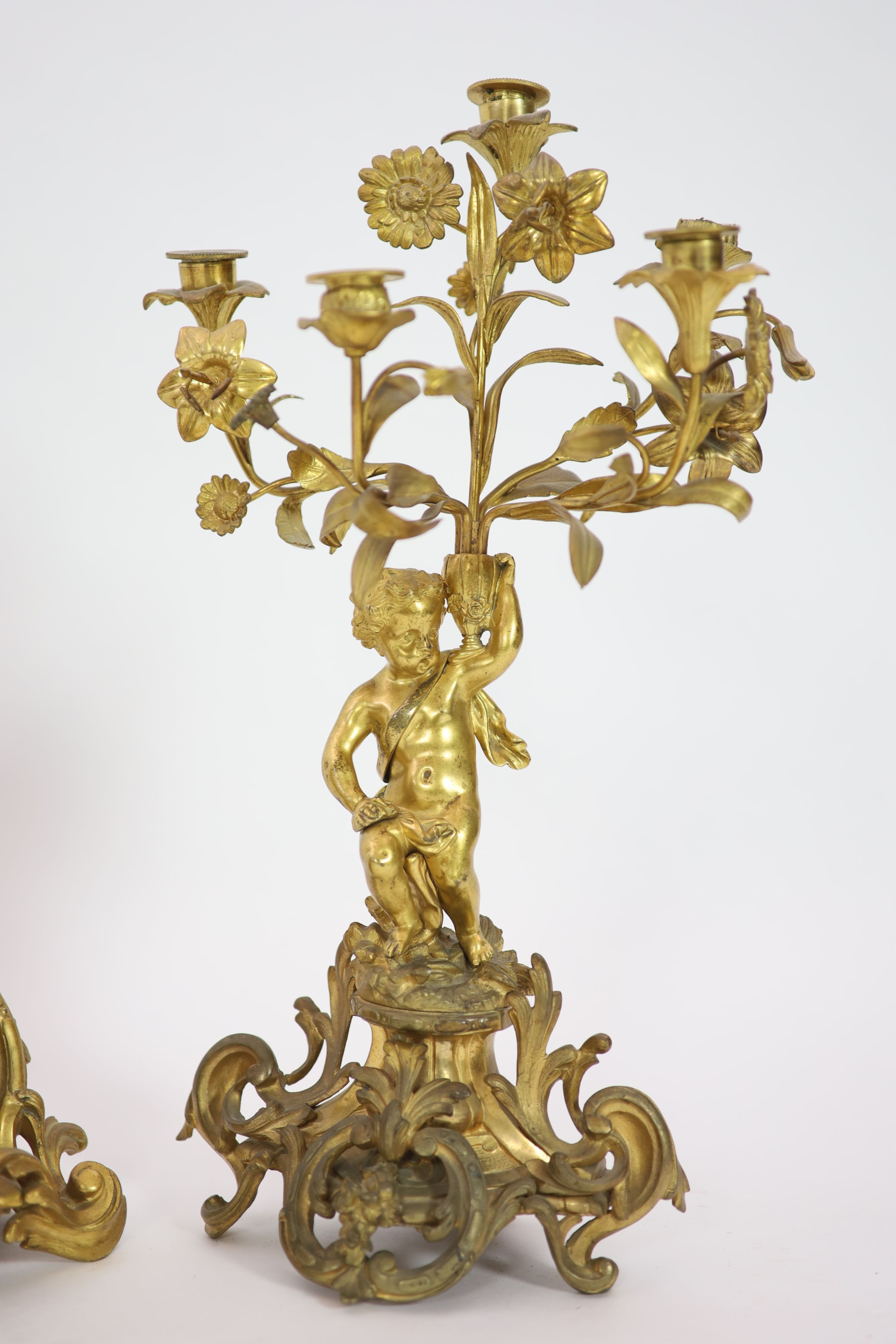 A 19th century Louis XV style ormolu clock garniture, clock H 43cm candelabra H 52cm